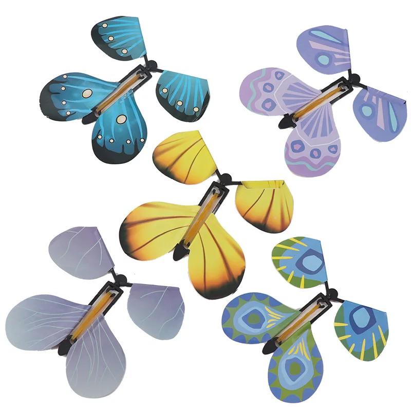 

Magic Wind Up Flying Butterfly in The Book Rubber Band Powered Magic Tricks Prop Fairy Flying Playthings Surprise Present Celebration Favor -A6907