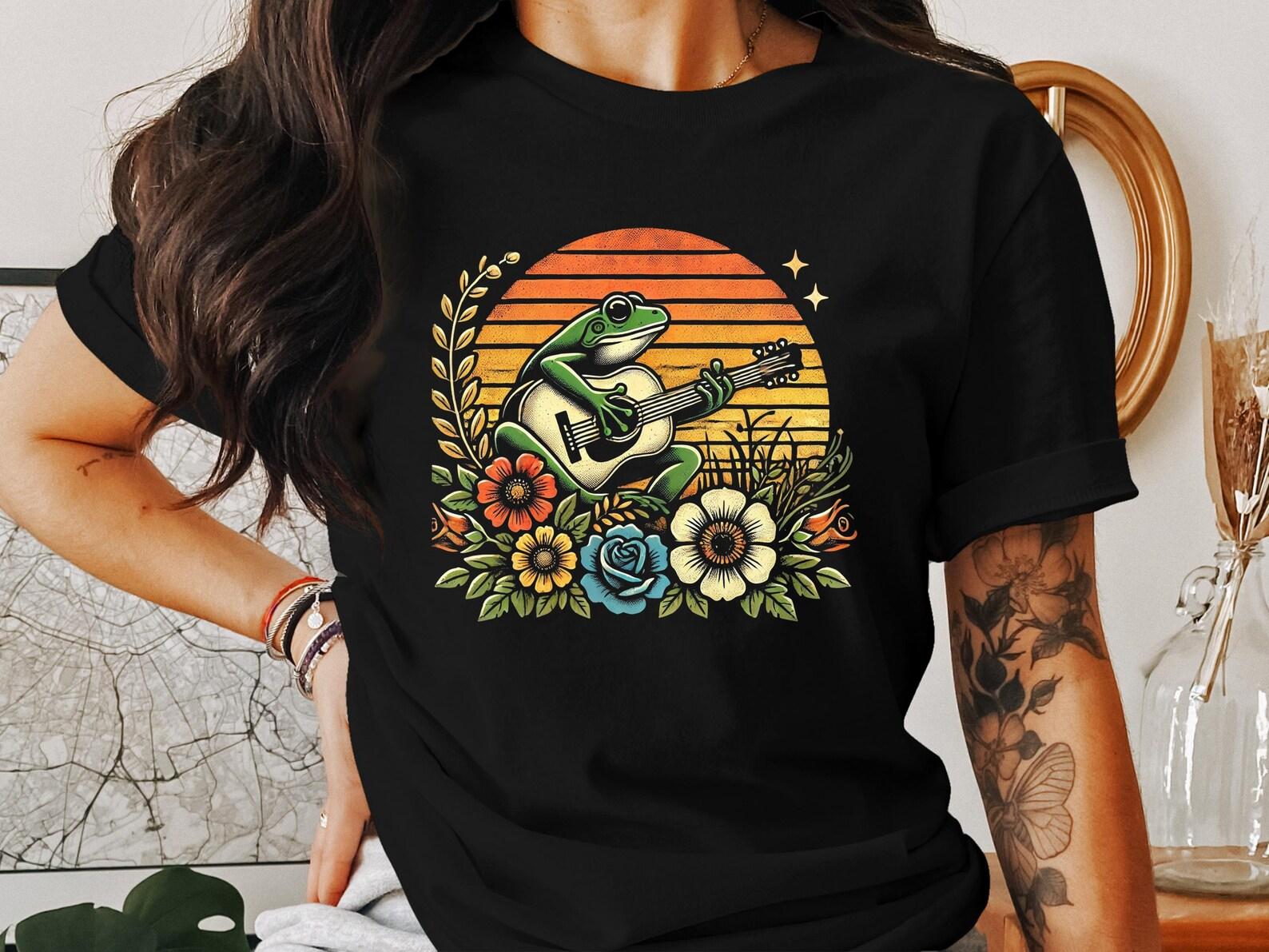 Retro Sunset Frog Playing Guitar Graphic T-Shirt, Cottagecore Frog Illustration Tee, Whimsical Frog and Flowers T-Shirt, Vintage Frog Design 3XL