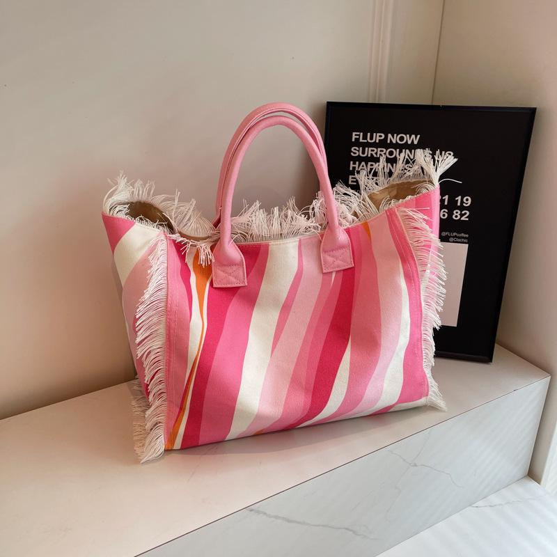 2026 Damen-Tragetasche für Reisen Strandtasche Große Kapazität Schulter-Pendlertaschen Hand-Quaste Jeans-Print Quaste Gespleißte Handtaschen