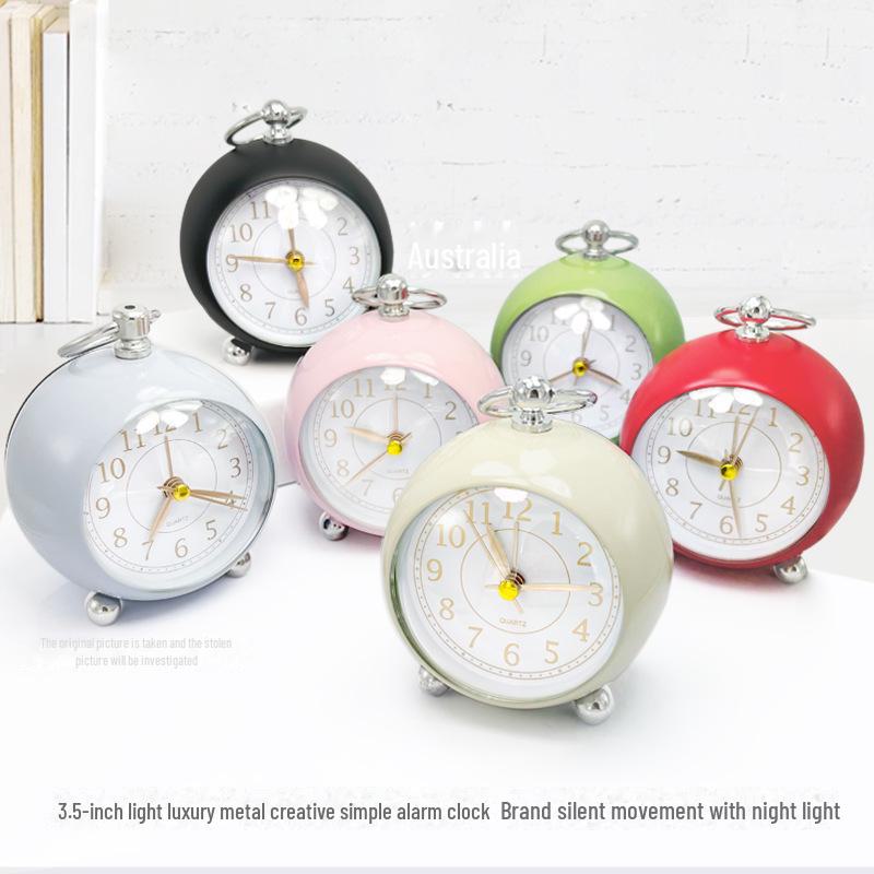Silent Metal Alarm Clock with Night Light and Gold Stamped Spherical Face - Perfect for Students and Children.