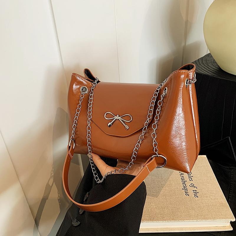 

High-end bow tote bag women s 2025 new commuter fashion versatile large-capacity chain one-shoulder crossbody bag коричневий