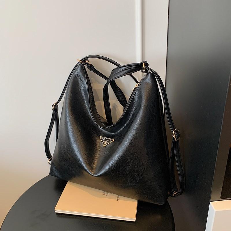 

Весна большая вместимость новая универсальная ретро сумка-тоут женская премиальная текстура кожа с масляной восковой пропиткой для通勤 повседневная сумка-мессенджер чёрный