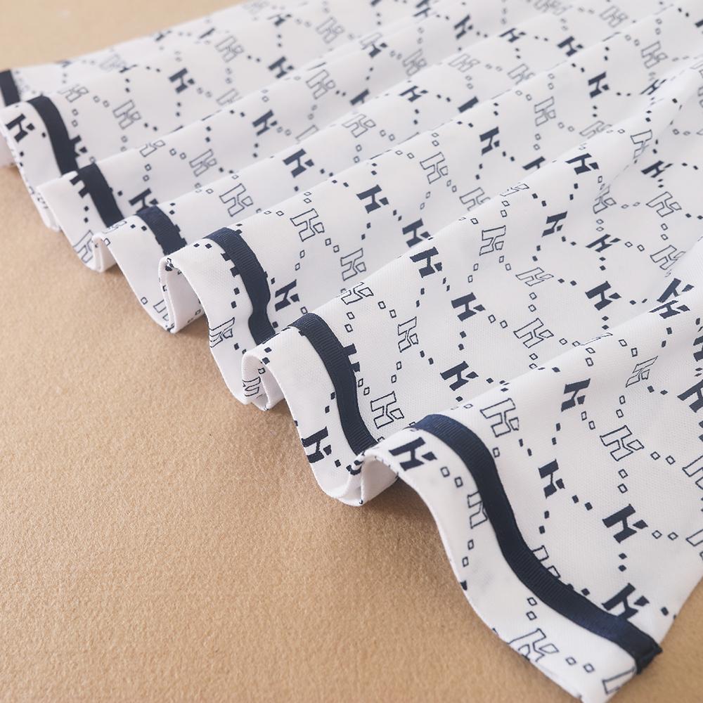 Flickornas tryckta pikétröja klänning med marinblå krage Kortärmad A-linjeformad klänning med monogrammönster Barnvita sommarklänningar