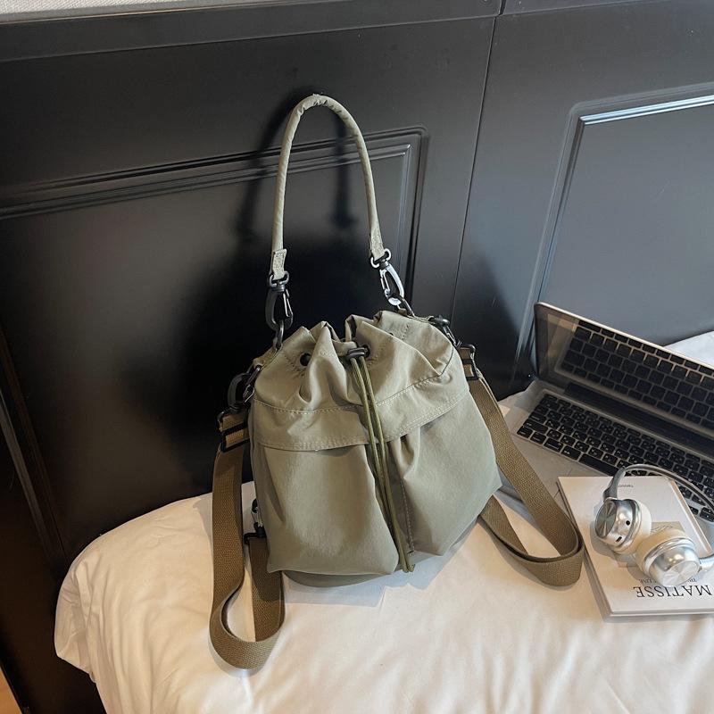 

Large capacity drawstring bucket bag bag women s multi-pocket messenger bag light casual cloth bag commuter bag зелений
