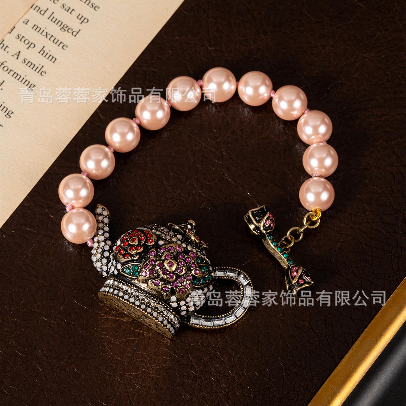 

Pink pearl enamel heavy-duty tea pot with full diamonds and precious jewelry pieces, exquisite ornaments.