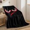 Red and white angry eyes with an arched red frown on a black background. for all seasons blanket lunch break throw gift
