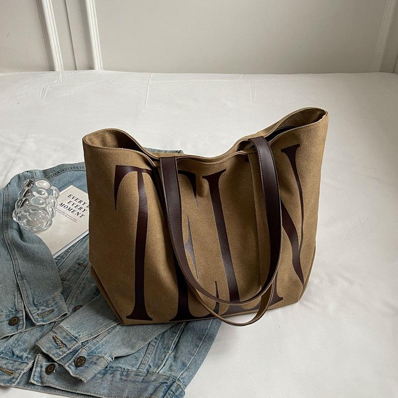 

Fashion Korean version ins niche letter printed canvas bag 2025 new casual mommy shopping bag shoulder bag хакі