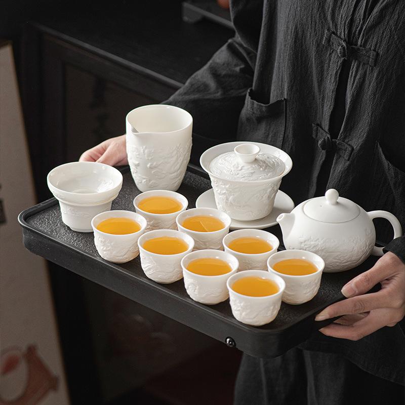 Suet jade porcelain Kung Fu tea set, household full set of ceramic cover bowl tea cup relief tea business gifts