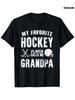 Men'S And Women'S "My Favorite Hockey Player Calls Me Grandpa" Hockey T-Shirt - Black Featuring a White Hockey Stick And Puck Desi