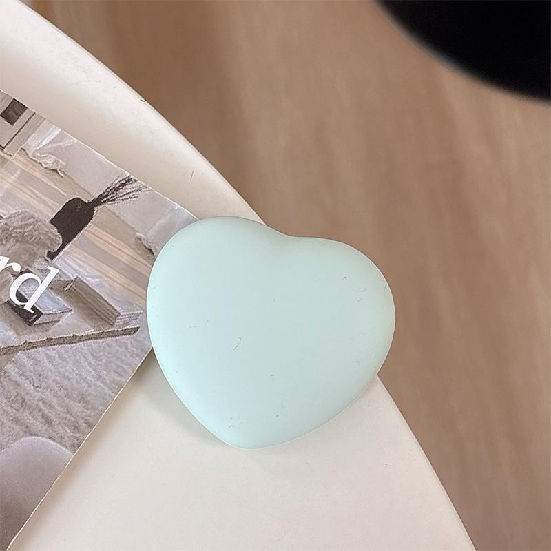 

Solid Color Wind Heart-Shaped Silicone Mobile Phone Airbag Bracket, Pasted And Retractable Watching Drama Desktop Bracket