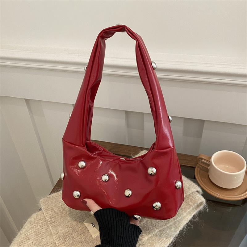 Internet celebrity armpit bag ladies 2025 new Korean version of fashion niche shoulder bag personalized rivets hand carry dumpling bag pu