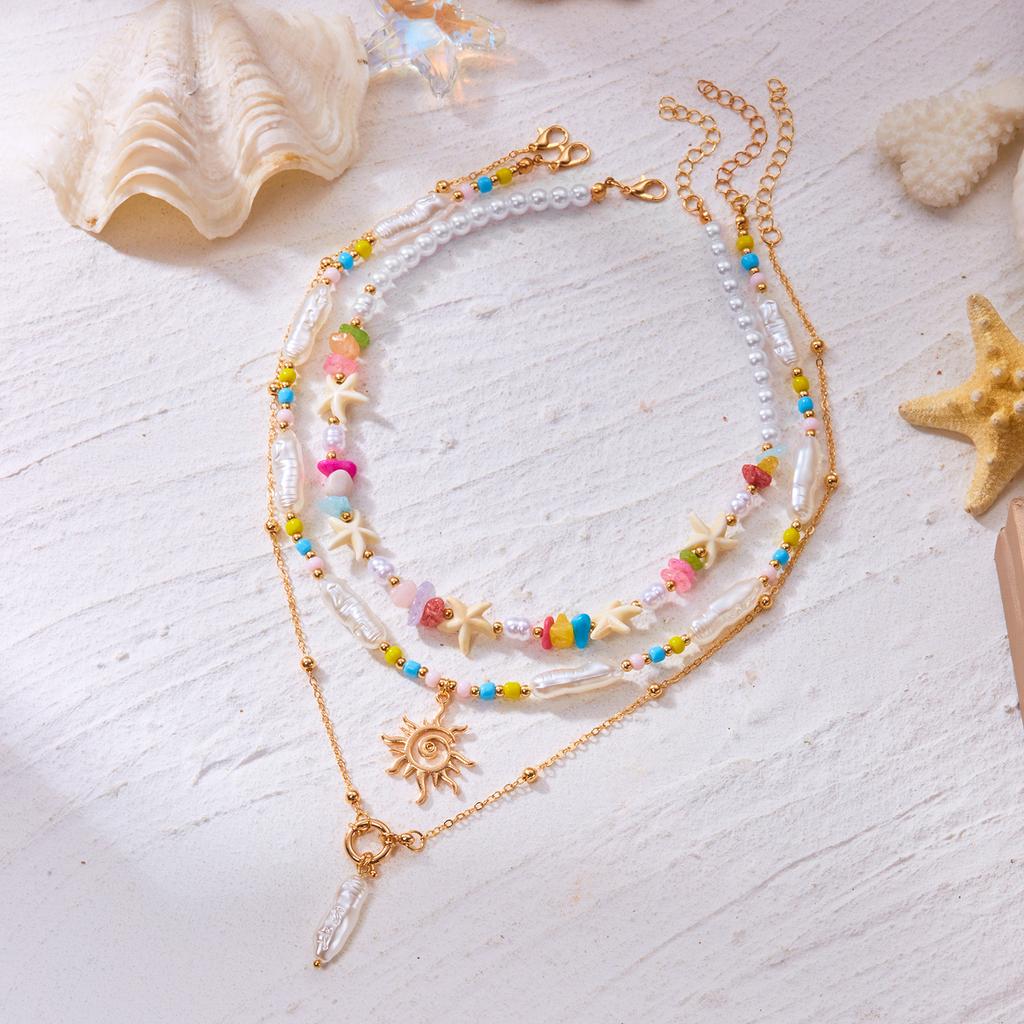 Bohemian Handgefertigter Seestern Sonne Anhänger Halskette für Damen Sommer Muschel Imitation Perle Reiskorn Perlen Choker Strandurlaub Schmuck