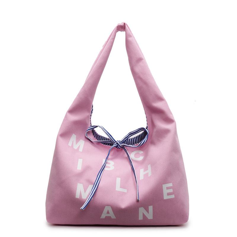 Large capacity double-sided canvas bag women's 2025 new color letter bow shoulder bag fashion student schoolbag