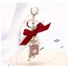 Korean-Style Handmade Rhinestone Perfume Bottle Keychain with Bow and Pearl Charm