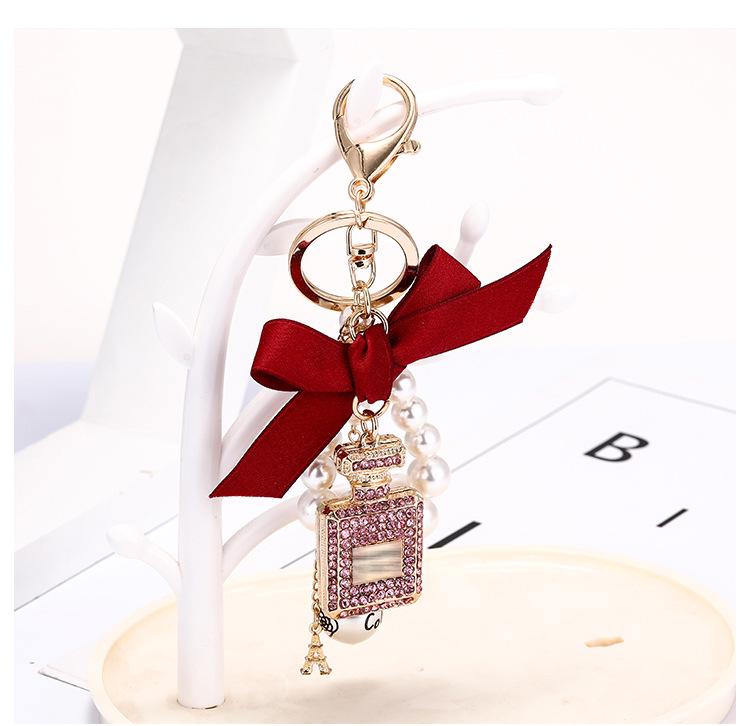 Korean-Style Handmade Rhinestone Perfume Bottle Keychain with Bow and Pearl Charm
