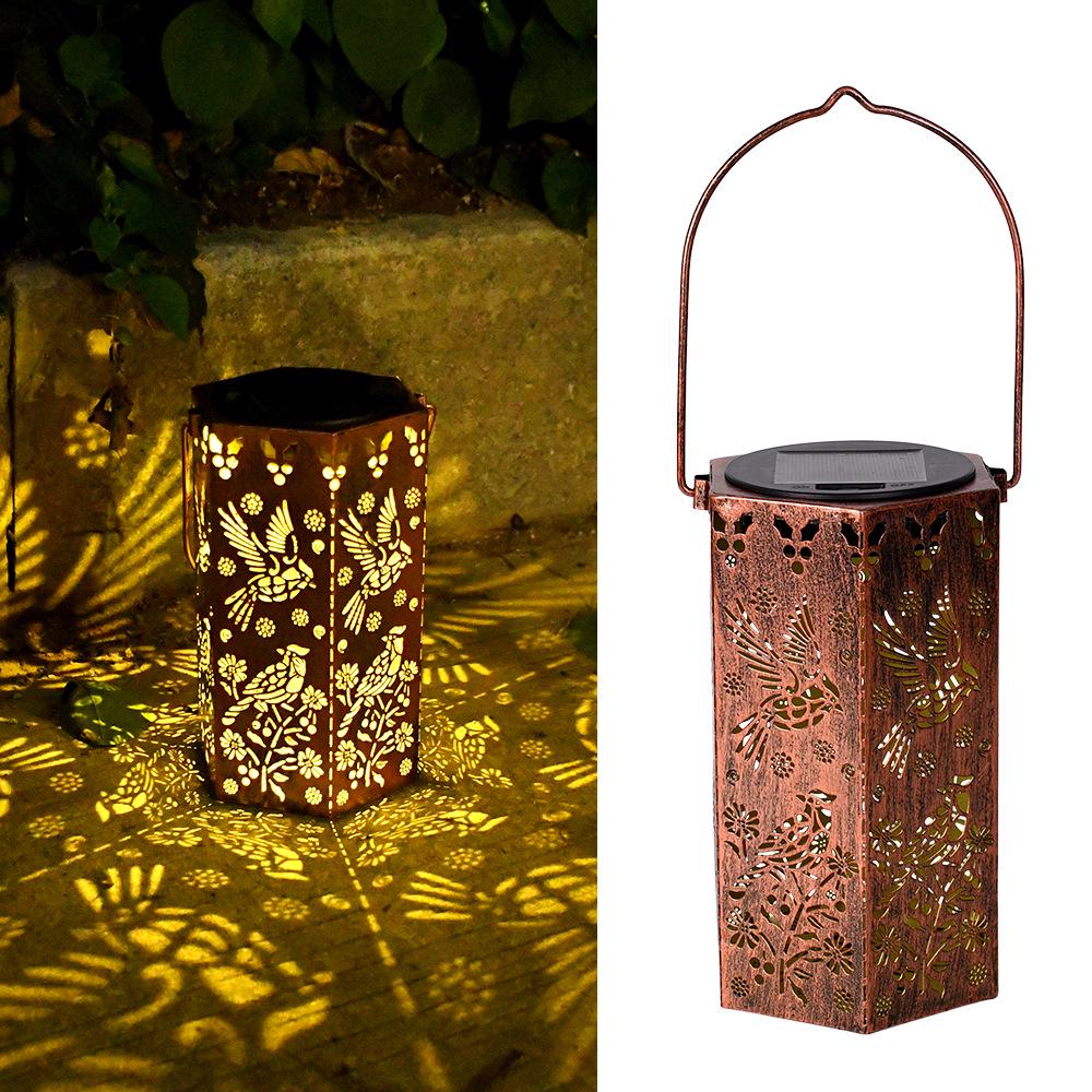 Outdoor Solar Wrought Iron Lantern: Waterproof Hollow Projection Table Lamp for Courtyard and Garden