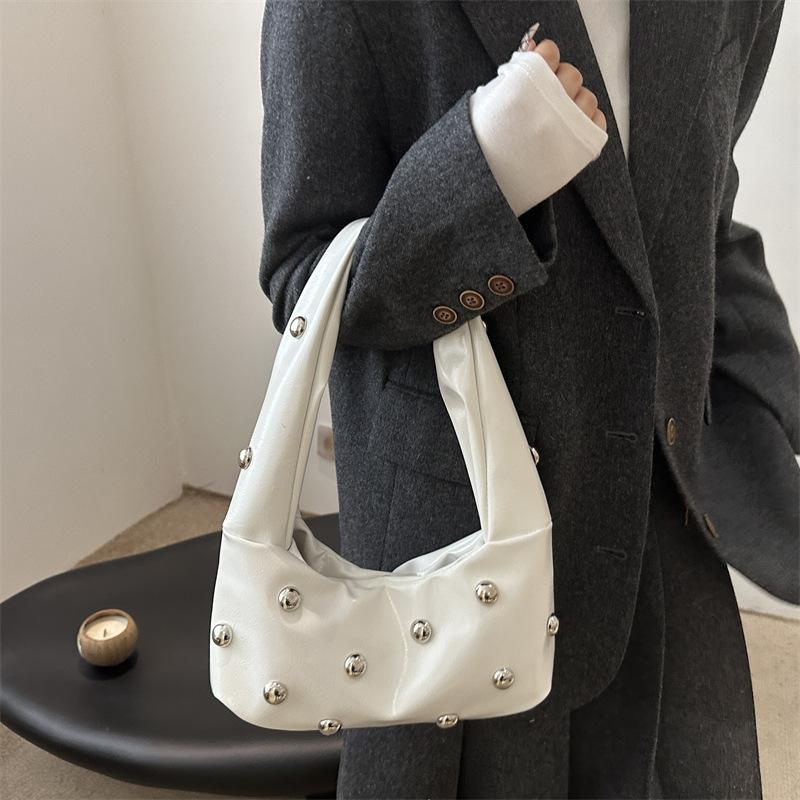 Internet celebrity armpit bag ladies 2025 new Korean version of fashion niche shoulder bag personalized rivets hand carry dumpling bag pu