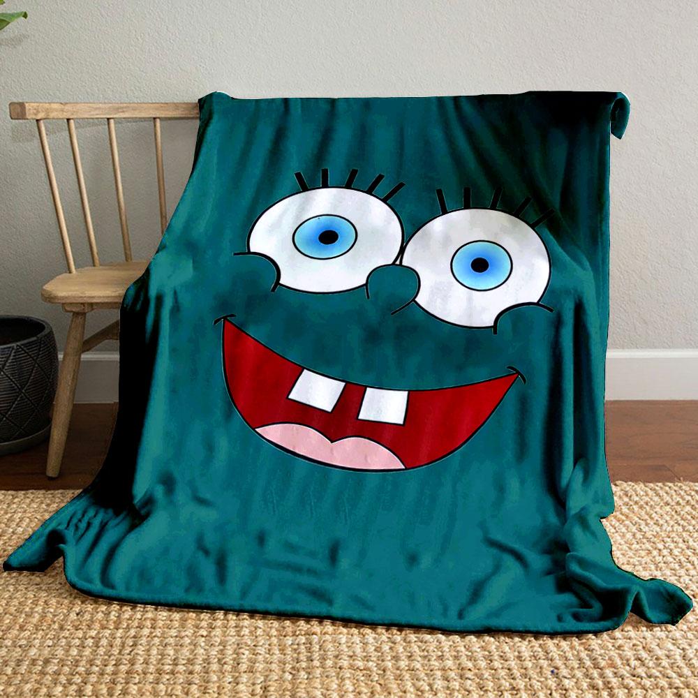 Bright cartoon face with large blue eyes, wide smile, and prominent teeth. for all seasons blanket lunch break throw gift