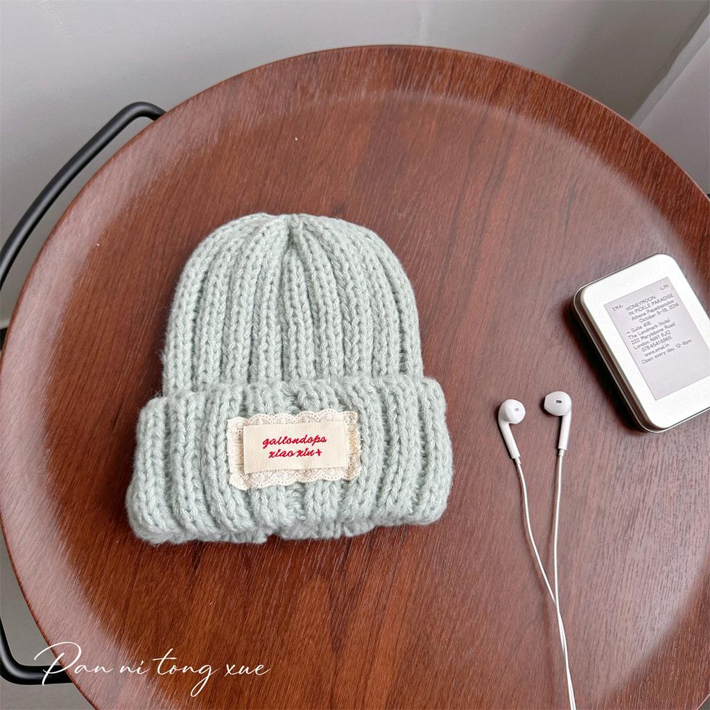Neue Spitze Etikett Kinder Wollmütze Nuojiji Student Herbst und Winter Neu Warm und Vielseitig Ohrenschutz Strickmütze