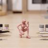 Crouching Figure with Smartphone | Compact 1/64 Scale Design, Detailed Resin Construction, Female
