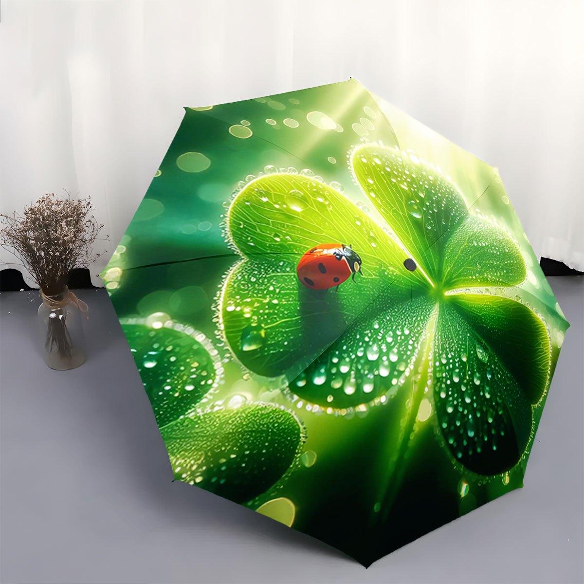 

Automatic Folding Umbrella A ladybug on a dewy green clover leaf. Portable collapsible design, casual outdoor accessory, for a Iron&8K