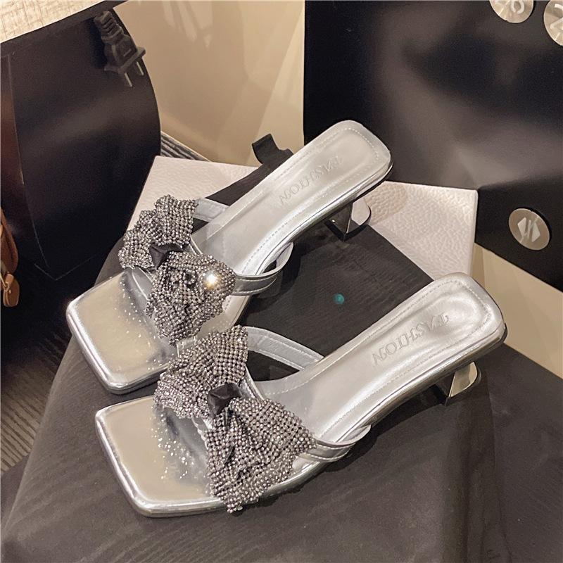 

One-word bow open-toed high-heeled rhinestone fashion fairy wind cool slippers 2025 new women s summer wear 35