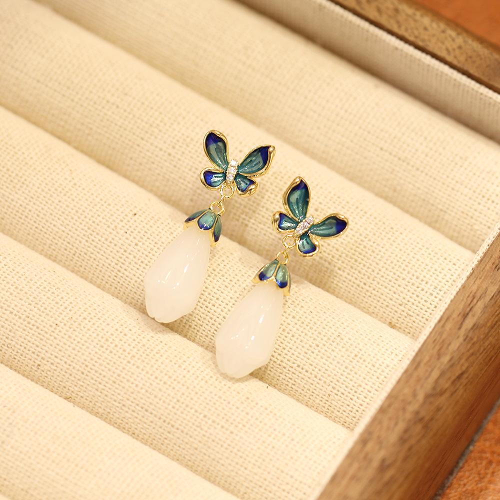 Elegant and elegant blue dripping butterfly stud earrings with simple temperament white magnolia flower imitation jade earrings silver needle women's