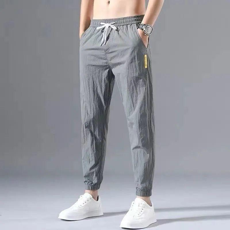 2023 Men's Korean-Style Ice Silk Casual Pants, Quick-Drying, Trendy, Loose-Fit Nine-Point Sports Pants for Summer.