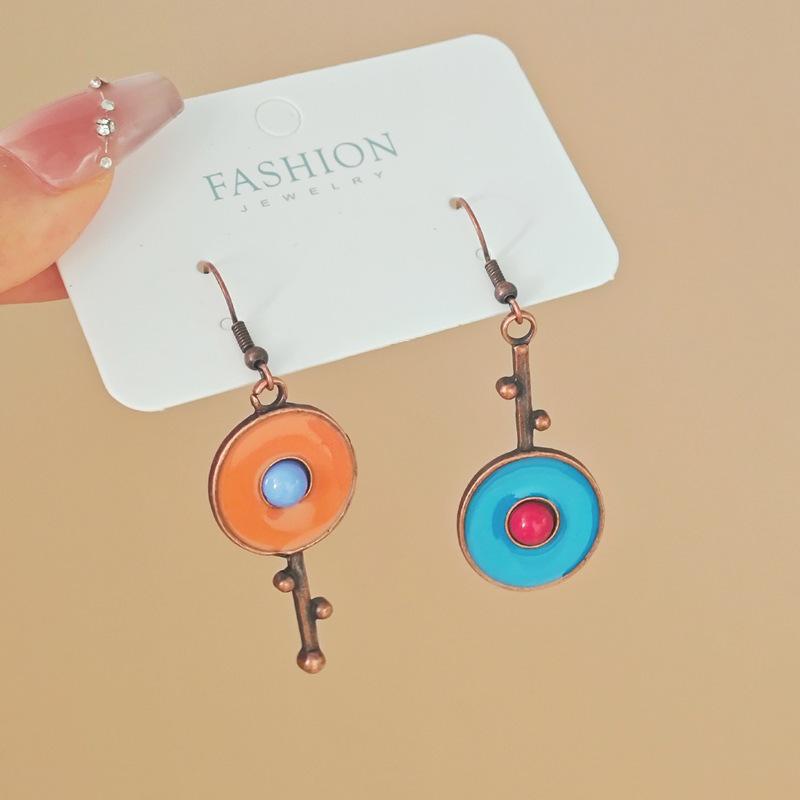 Асимметричные серьги из красной меди с граффити и бриллиантовыми кисточками