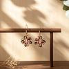 Explosive hollow flower enamel color earrings European and American style line winding earrings commuting versatile light luxury earrings