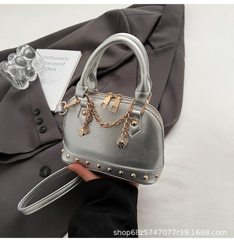 2025 new niche design high-end champagne rivet portable shell bag women's fashionable foreign style shoulder messenger bag