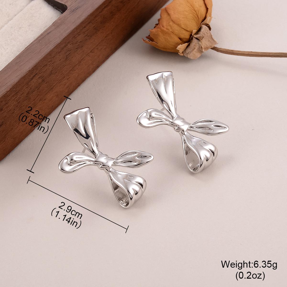 

European and American bow metal earrings geometric women s new light luxury fashion temperament stud earrings collection jewelry