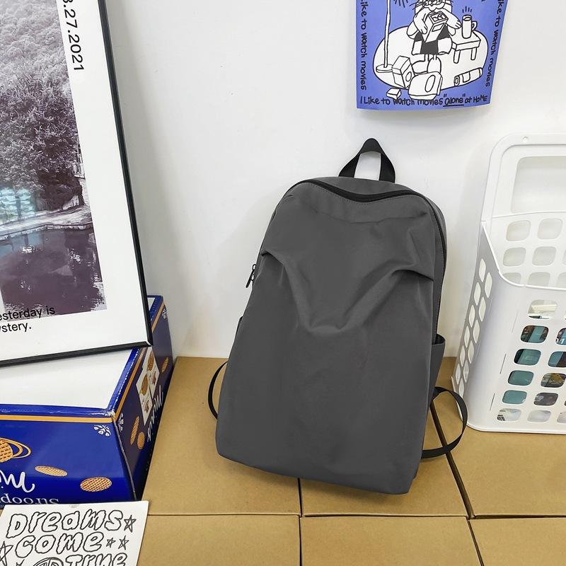 

Backpack men s large-capacity personalized pleated travel couple backpack simple and lightweight anti-splashing college student schoolbag women серый