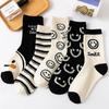 Women's Mid-Tube Japanese Cartoon Cute Black & White Smiley Face Socks, Trendy Korean Style, Perfect for Sports & Students.