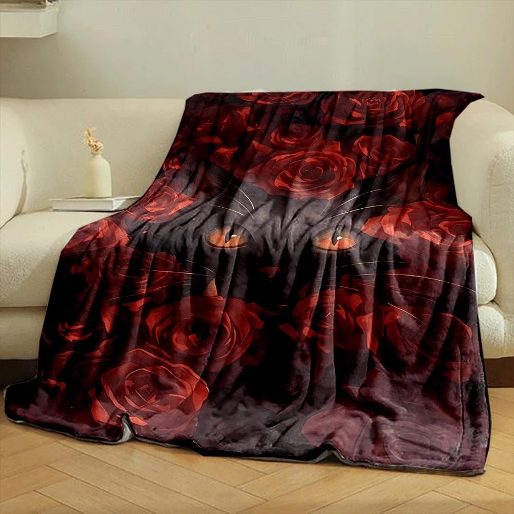 A black cat's face surrounded by vibrant red roses. for all seasons blanket lunch break throw gift