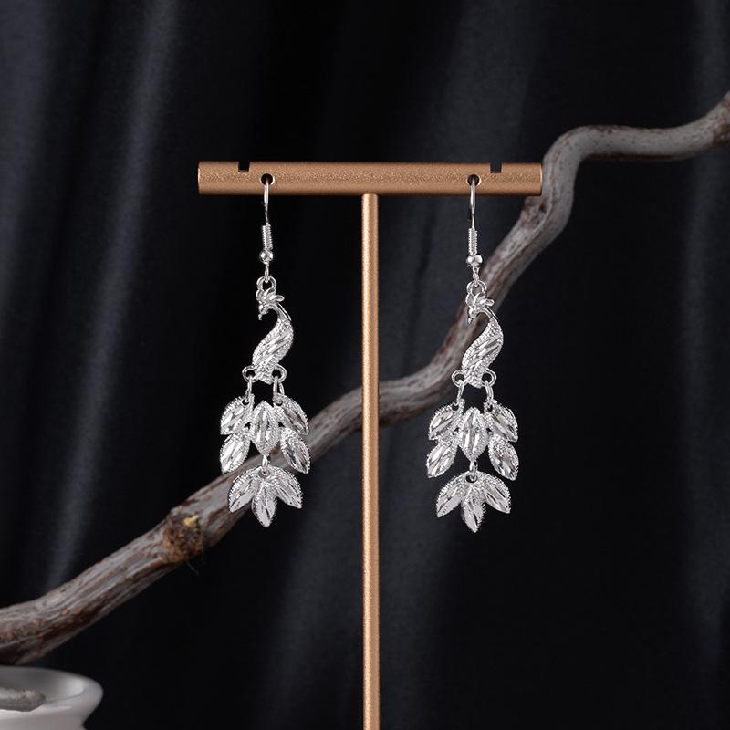 Bohemian Ethnic Miao Silver Tassel Earrings with Butterfly, Peacock, and Flower Design for Women – Long Dangle Jewelry for Travel Photos.