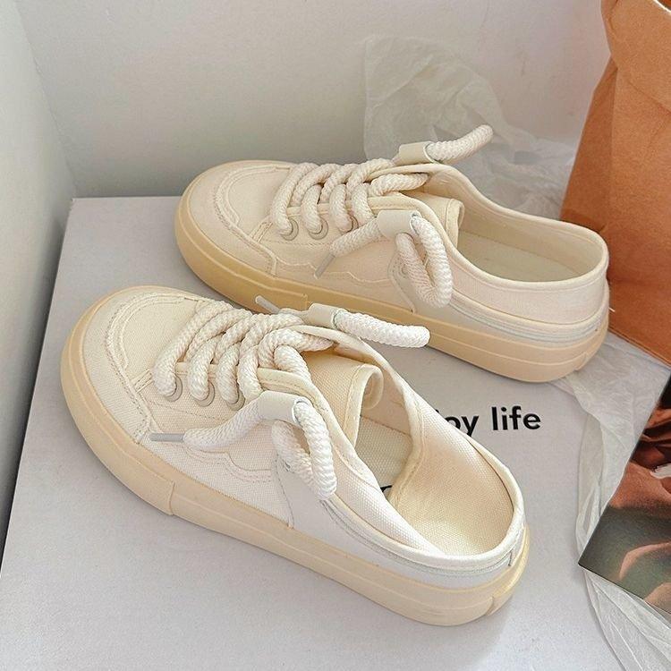 The heel can be stepped on half-towed canvas shoes for women's 2025 spring new niche original versatile little white shoes with skirts for women'