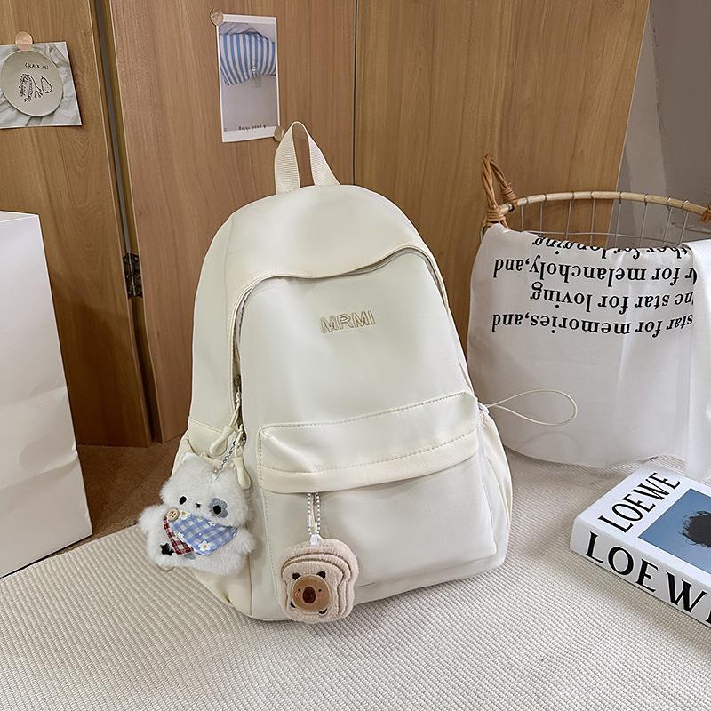 Cream school bag for female junior high school students, high-value niche computer travel backpack, simple and versatile college student backpack