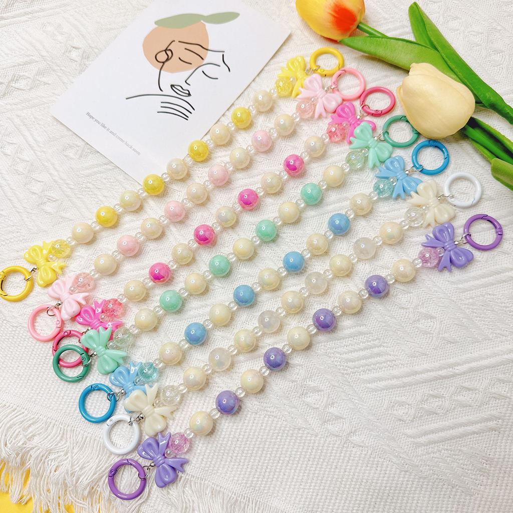Handmade candy-colored bow bead pendant phone case chain for female students - beaded hand-held jewelry and bag accessory.
