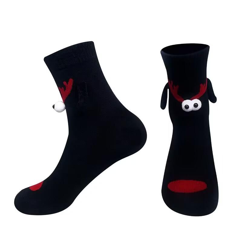 A pair of socks Fabric Christmas Socks - 3D Eyes Magnetic Cartoon Design, Hand-in-Hand Mid-Calf Playful Holiday Gift