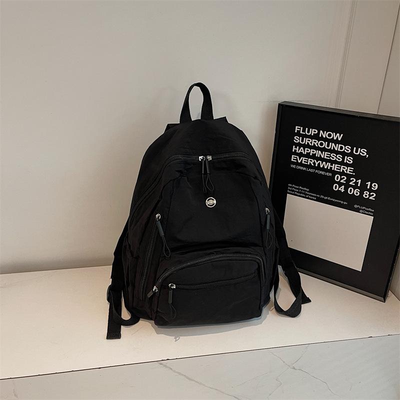 High-value solid color Korean version of the new popular simple fashion versatile light Japanese commuting travel backpack women