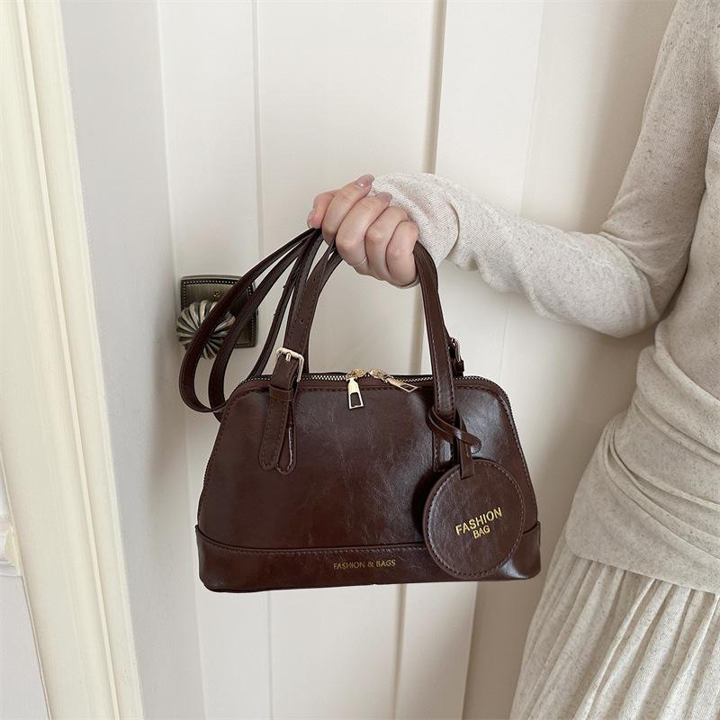 

Large capacity foreign style new fashion color matching casual simple large capacity armpit shoulder crossbody handbag women темно-коричневого