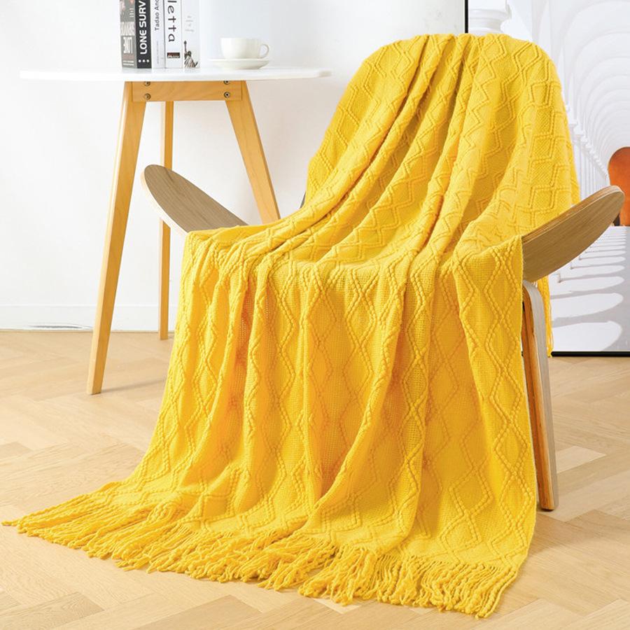 Orange knitted throw blanket for model homes, suitable for use as a sofa or bed throw, for furniture stores and home showrooms as a soft decoration