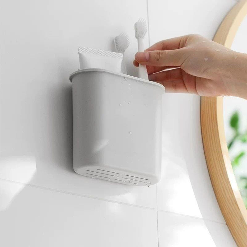 Levitating water-draining toothbrush holder
