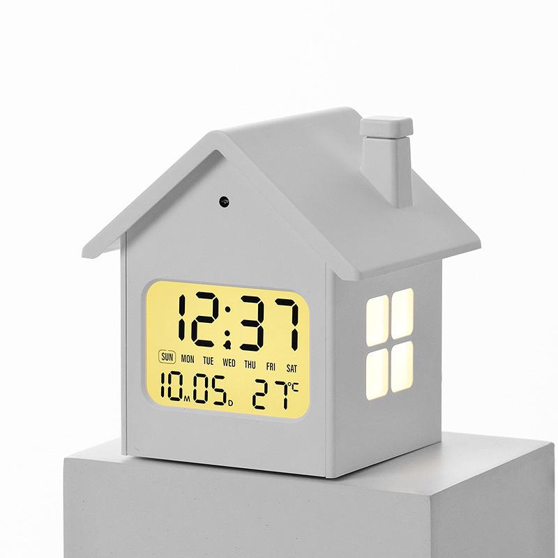 Hausförmiger Multifunktionaler Kinderwecker mit Nachtlicht und LCD-Anzeige.