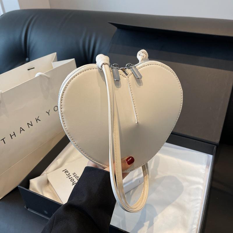 Niche design mini bag women's 2025 new fashion solid color love headphone bag crossbody change lipstick bag