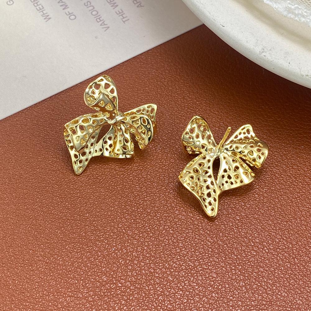 Chic Metal Hollow Bow Earrings: Unique European & American Cool Style