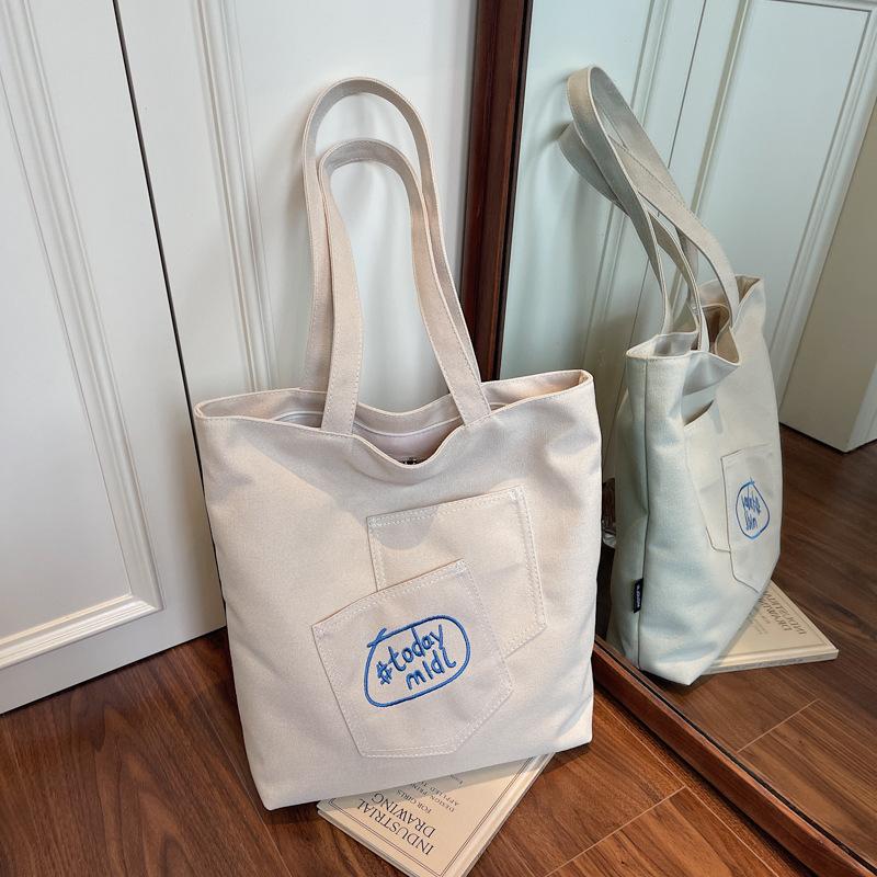 

Casual literary and artistic style canvas bag women s 2025 new embroidered letter armpit bag large capacity shoulder tote bag брудно-білий