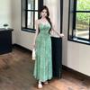 The green polka dot v-neck suspender holiday dress worn by the sea is very beautiful, and the small waist skirt is 2026 summer.