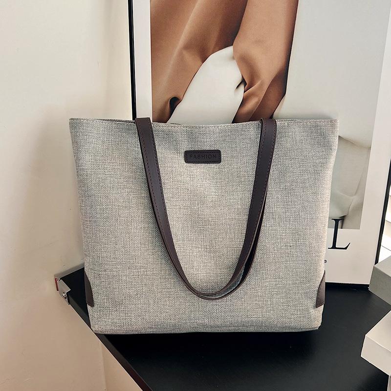 Cotton and linen casual tote bags are hot-selling large-capacity portable bucket bags, fashionable and simple solid-color shoulder bags.